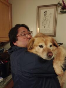 Emerson, a stately elder dog, loves being held.